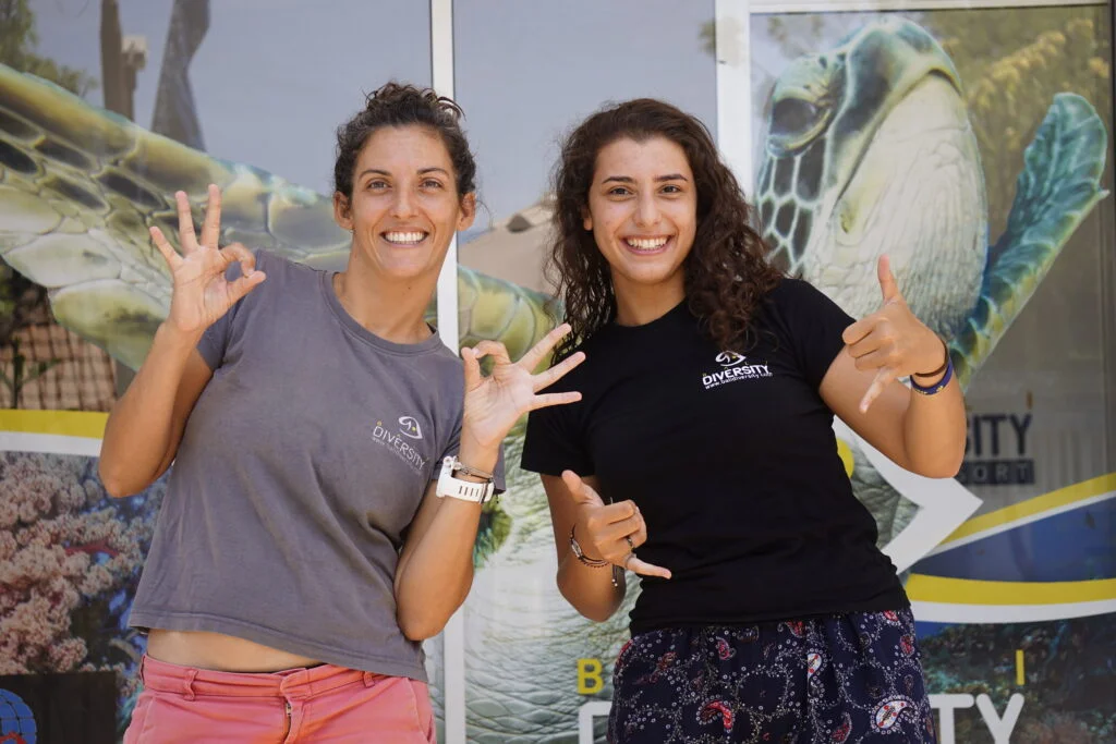 two women in front of a diving club