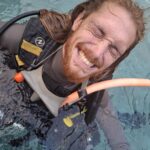 PADI Instructor mentoring Assistant Instructor trainee during pool session at Bali Diversity